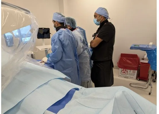 The Embolix team performing an embolization procedure, guiding the catheter while watching the live X-ray screen.